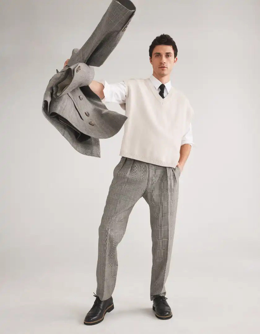 Man in tan suit laying down with feet up wearing sneakers